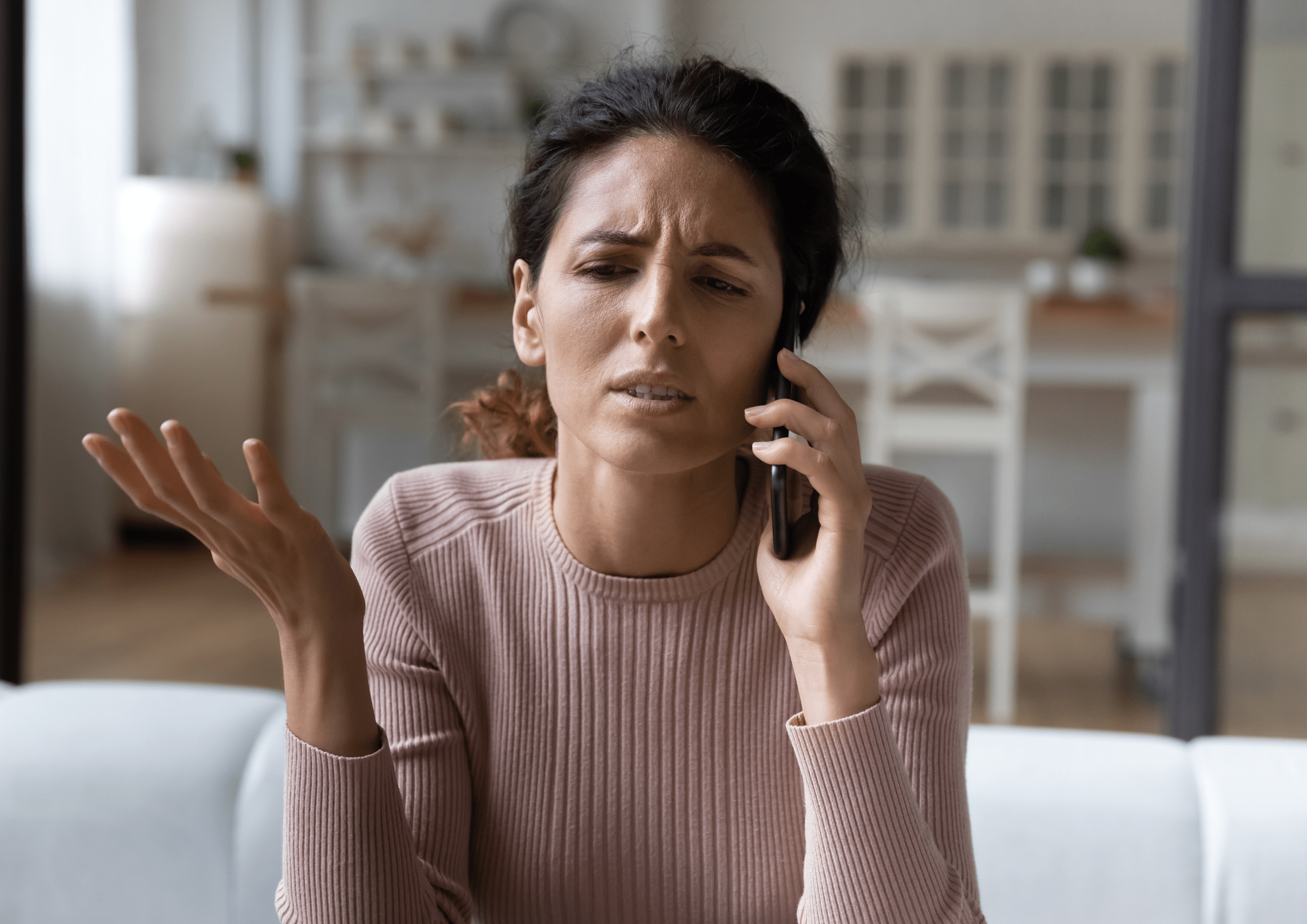Woman looking agitated is on the phone